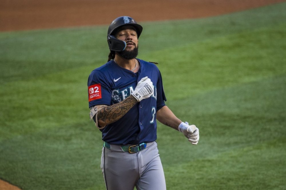 Seattle Mariners' J.P. Crawford reacts after hitting a solo home run during the first inning of a baseball game against the Texas Rangers, Saturday, May 3, 2025, in Arlington, Texas. (AP Photo/Jessica Tobias)