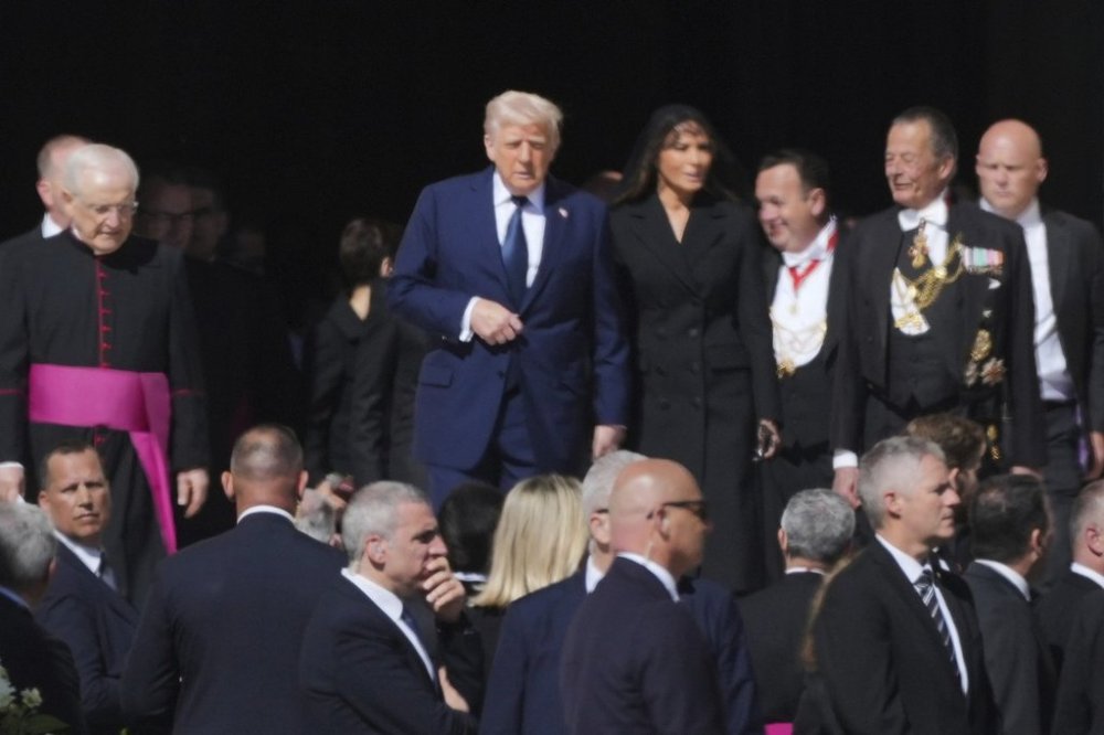 President Donald Trump and first lady Melania Trump, center, and other guests arrive, for the funeral of Pope Francis in St. Peter's Square at the Vatican, Saturday, April 26, 2025. (AP Photo/Andrew Medichini)