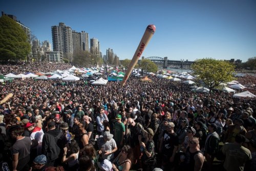 An inflatable shaped like a joint is tossed above the crowd during the annual 4-20 marijuana celebration in Vancouver on Saturday, April 20, 2019. The Vancouver Park Board says it's gearing up for 
