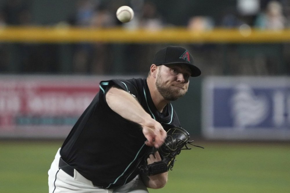 Arizona Diamondbacks pitcher Corbin Burnes throws against the Milwaukee Brewers in the first inning during a baseball game, Saturday, April 12, 2025, in Phoenix. (AP Photo/Rick Scuteri)