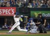 Texas Rangers' Adolis García follows through on a walk-off two run home run that scored Josh Smith off of Los Angeles Dodgers pitcher Kirby Yates during the ninth inning of a baseball game Saturday, April 19, 2025, in Arlington, Texas. (AP Photo/Jeffrey McWhorter)