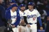 Los Angeles Dodgers' Miguel Rojas, left, and Shohei Ohtani chat after the Los Angeles Dodgers defeated the Colorado Rockies 8-7 in a baseball game Wednesday, April 16, 2025, in Los Angeles. (AP Photo/Mark J. Terrill)