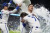 Kansas City Royals' Bobby Witt Jr. (7) and Freddy Fermin are doused by teammates after their baseball game against the Chicago White Sox, Tuesday, May 6, 2025, in Kansas City, Mo. (AP Photo/Charlie Riedel)