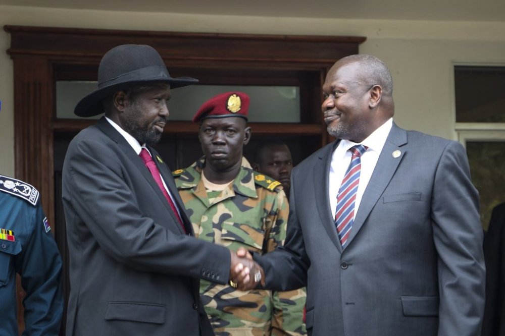 FILE - South Sudan's president Salva Kiir, left, and vice-president Riek Machar, right, shake hands after meetings to discuss outstanding issues to the peace deal on Oct. 20, 2019. (AP Photo/Sam Mednick, File)