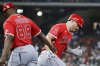 Los Angeles Angels' Mike Trout, right, celebrates after his home run with first base coach Bo Porter (88) as he rounds the bases against the Houston Astros during the fourth inning of a baseball game Friday, April 11, 2025, in Houston. (AP Photo/Michael Wyke)