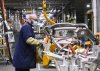 GM workers use human assisted automation to weld vehicle doors at the General Motors assembly plant in Oshawa, Ont., on Friday, March 19, 2021. THE CANADIAN PRESS/Nathan Denette