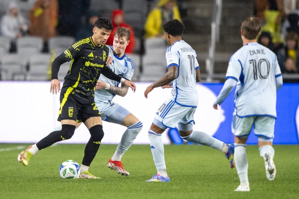Columbus Crew forward Max Arfsten (27) tries to control the ball against CF Montréal defenders during the second half of an MLS game on April 5, 2025, in Columbus, Ohio. (AP Photo/Tanner Pearson)