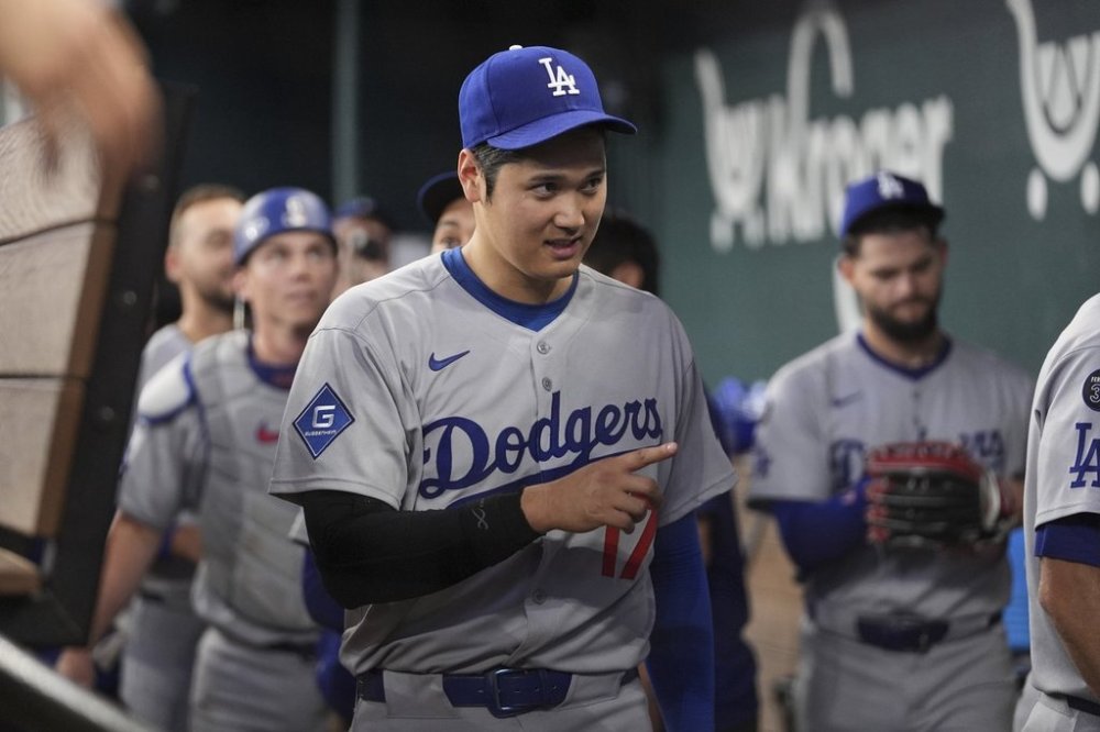 Los Angeles Dodgers' Shohei Ohtani celebrates the team's win following a baseball game against the Texas Rangers in Arlington, Texas, Sunday, April 20, 2025. (AP Photo/Tony Gutierrez)