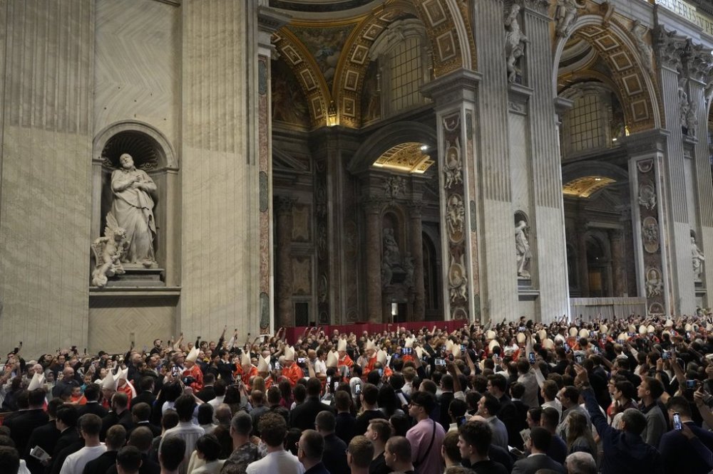 Faithful capture images with their smartphones of cardinals arriving during a final Mass inside St. Peter's Basilica before the conclave to elect a new pope, at the Vatican, Wednesday, May 7, 2025. (AP Photo/Gregorio Borgia)