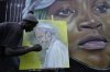 FILE - Graffiti artist Alexander Ikawah, paints Pope Francis on a canvas in Nairobi, Kenya Monday, April 21, 2025. (AP Photo/Brian Inganga, File)