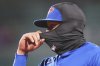 Toronto Blue Jays first baseman Vladimir Guerrero Jr., with temperatures in the 30's, adjusts his balaclava during sixth inning of a baseball game against the Boston Red Sox, Tuesday, April 8, 2025, in Boston. (AP Photo/Charles Krupa)