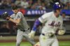Arizona Diamondbacks pitcher Shelby Miller, left, throws to first base as New York Mets' Jeff McNeil beats the throw for a single during the eighth inning of a baseball game Wednesday, April 30, 2025, in New York. (AP Photo/Frank Franklin II)