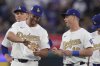 Los Angeles Dodgers' Clayton Kershaw and Will Smith show each other their rings during a World Series Champion ring ceremony prior to a baseball game against the Detroit Tigers, Friday, March 28, 2025, in Los Angeles. (AP Photo/Mark J. Terrill)