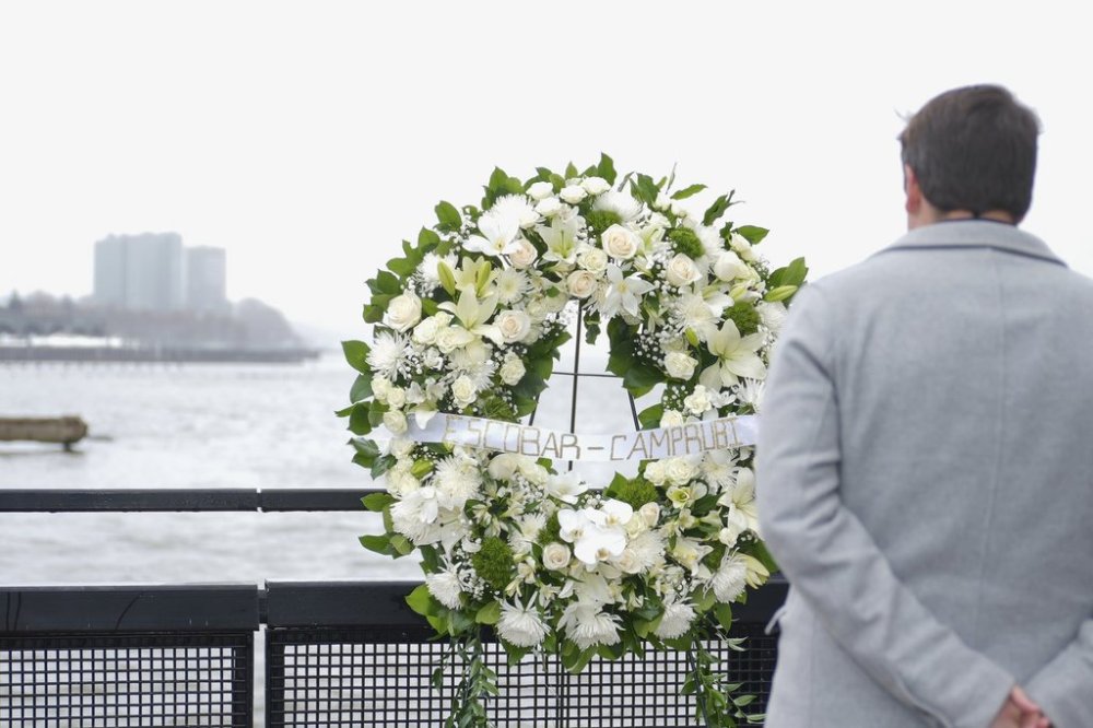 Joan Camprubí Montal, a family member of five of the victims who died in the Hudson River helicopter crash, looks at a memorial wreath on Saturday, April 12, 2025 in New York. (Justin Persaud/Mayoral Photography Office via AP)
