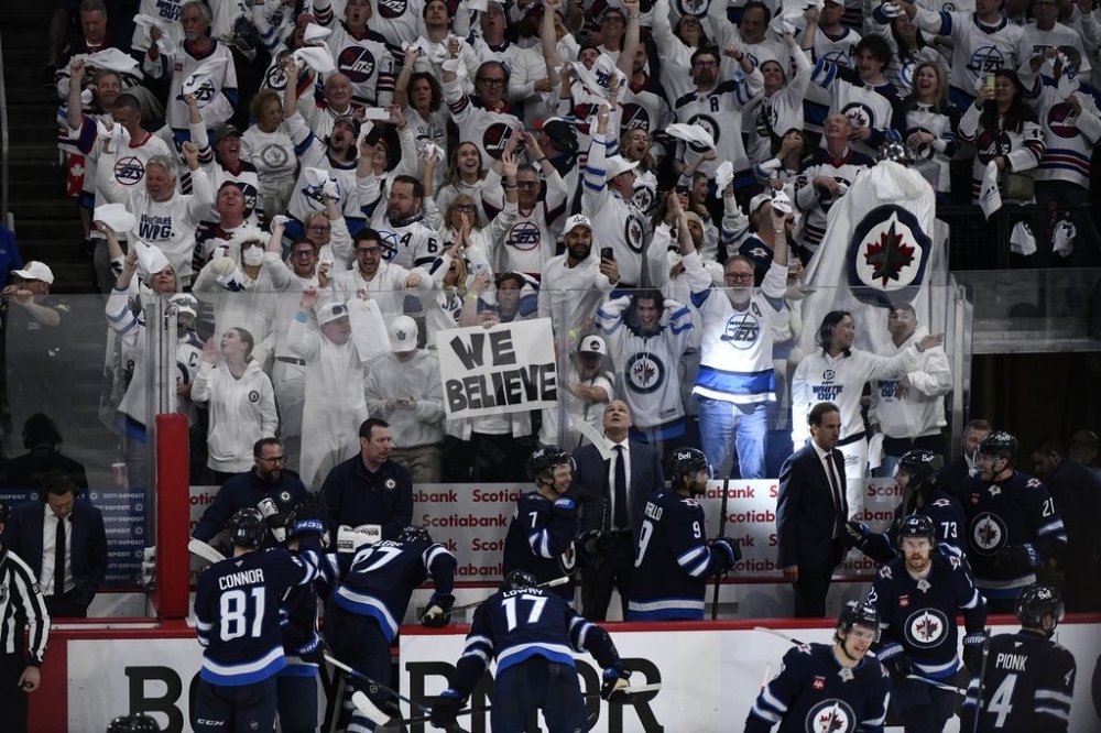 Winnipeg Jets fans celebrate the Jets third goal against the St. Louis Blues during third period NHL round one, game seven Stanley Cup playoff action in Winnipeg, Sunday May 4, 2025. THE CANADIAN PRESS/Fred Greenslade