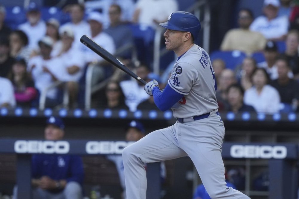 Los Angeles Dodgers' Freddie Freeman (5) hits a single to center field during the first inning of a baseball game against the Miami Marlins, Wednesday, May 7, 2025, in Miami. (AP Photo/Marta Lavandier)