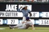 Washington Nationals shortstop CJ Abrams, top, gets a force out against New York Mets' Pete Alonso (20) and attempts to turn a double play on a ball hit by Brandon Nimmo during the first inning of a baseball game in Washington, Friday, April 25, 2025. (AP Photo/Terrance Williams)