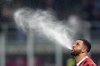 AC Milan's Kyle Walker spits out water during an Italian Cup semi final first leg soccer match between AC Milan and Inter Milan at the San Siro stadium, in Milan, Italy, Wednesday, April 2, 2025.. (Spada/LaPresse via AP)