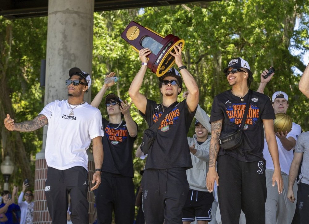 Florida guard Walter Clayton Jr. holds up the trophy as the team arrives at the University of Florida after winning the NCAA national basketball championship, Tuesday, April 8, 2025, in Gainesville, Fla. (AP Photo/Alan Youngblood)