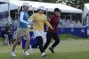 Mao Saigo, of Japan, in yellow, prepares to dive into the water off the 18th green after winning the Chevron Championship LPGA golf tournament Sunday, April 27, 2025, in The Woodlands, Texas. (AP Photo/Ashley Landis)