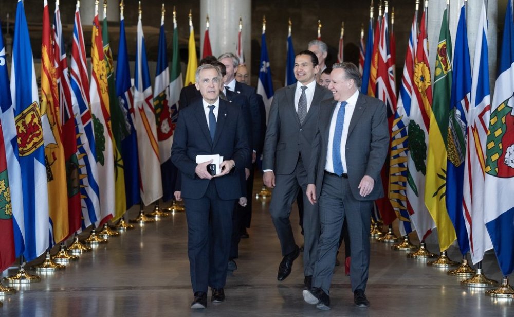Prime Minister Mark Carney, front left, walks alongside Quebec Premier Francois Legault as first ministers arrive for a meeting at the National War Museum in Ottawa on Friday, March 21, 2025. THE CANADIAN PRESS/Adrian Wyld