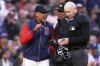 Boston Red Sox manager Alex Cora, left, argues with home plate umpire Mike Estabrook after being ejected during the third inning of a baseball game against the New York Mets at Fenway Park, Tuesday, May 20, 2025, in Boston. (AP Photo/Charles Krupa)