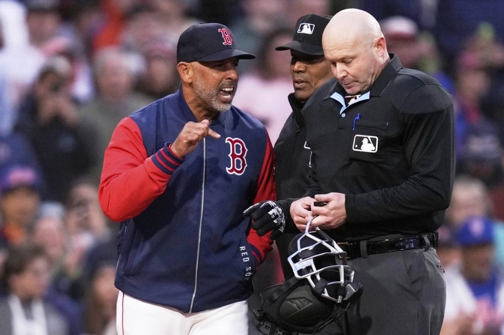 Boston Red Sox manager Alex Cora, left, argues with home plate umpire Mike Estabrook after being ejected during the third inning of a baseball game against the New York Mets at Fenway Park, Tuesday, May 20, 2025, in Boston. (AP Photo/Charles Krupa)