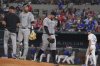 Colorado Rockies starting pitcher Antonio Senzatela, right, leaves play as interim manager Warren Schaeffer, left, and catcher Jacob Stallings stand on the mound during the fifth inning of a baseball game against the Texas Rangers, Wednesday, May 14, 2025, in Arlington, Texas. (AP Photo/LM Otero)