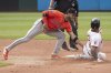 Houston Astros' Jeremy Pena, left, tags Cleveland Guardians' Gabriel Arias, right, out on a steal attempt during the fourth inning of a baseball game, Saturday June 7, 2025, in Cleveland. (AP Photo/Phil Long)
