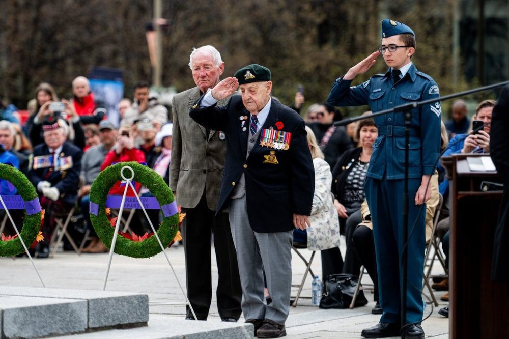 Second World War veteran Roland Lalonde, centre, salutes after placing a wreath with fellow Second World War veteran Roy Martel during a ceremony marking the 80th anniversary of the Liberation of the Netherlands and Victory in Europe Day at the National War Memorial in Ottawa on Thursday, May 8, 2025. THE CANADIAN PRESS/Spencer Colby