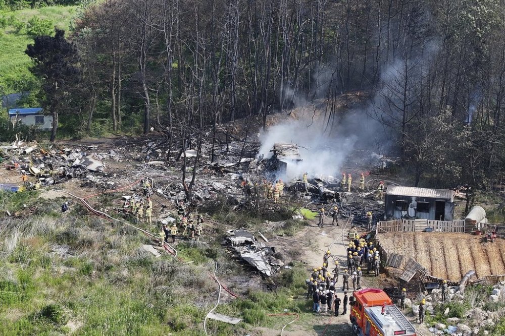 South Korean firefighters and military officers work at the scene of a South Korean navy plane's crash in Pohang, South Korea, Thursday, May 29, 2025. (Yun Kwan-shik/Yonhap via AP)