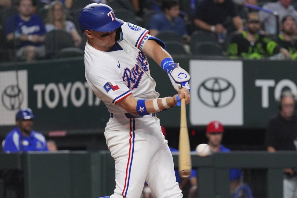 Texas Rangers' Josh Jung hits a home run during the first inning of a baseball game against the Colorado Rockies, Tuesday, May 13, 2025, in Arlington, Texas. (AP Photo/LM Otero)