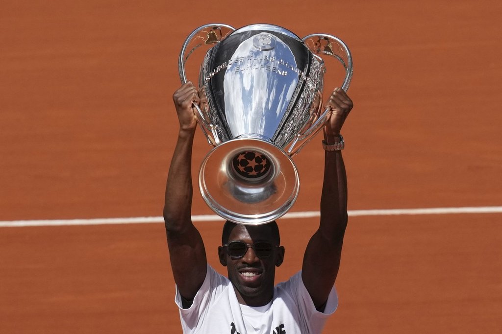 PSG star Dembélé raises Champions League trophy at the French Open