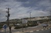 A young Israeli settler walks to a bus stop outside of the West Bank settlement of Bruchin on Thursday, May 15, 2025. (AP Photo/Maya Alleruzzo)