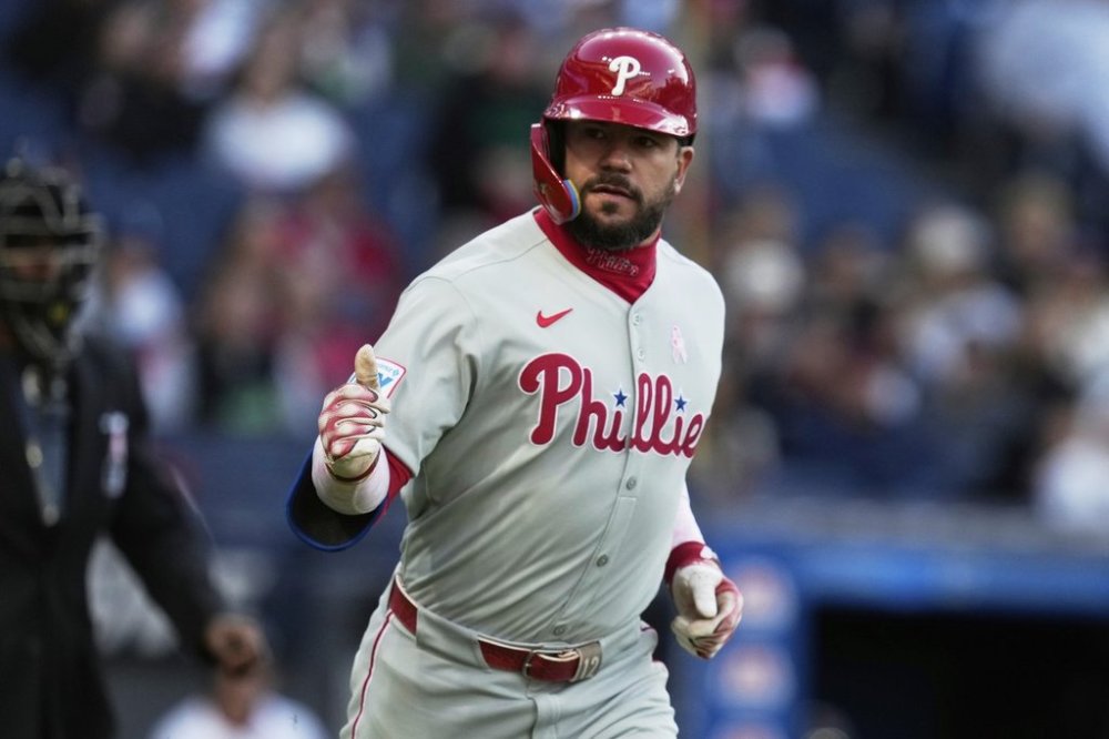 Philadelphia Phillies' Kyle Schwarber gestures to the dugout as he runs toward first base with a home run in the second inning of a baseball game against the Cleveland Guardians in Cleveland, Sunday, May 11, 2025. (AP Photo/Sue Ogrocki)