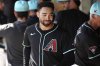 FILE - Arizona Diamondbacks' Jordan Lawlar walks through the dugout prior to a spring training baseball game against the Cleveland Guardians on Feb. 24, 2025, in Scottsdale, Ariz. (AP Photo/Ross D. Franklin, File)