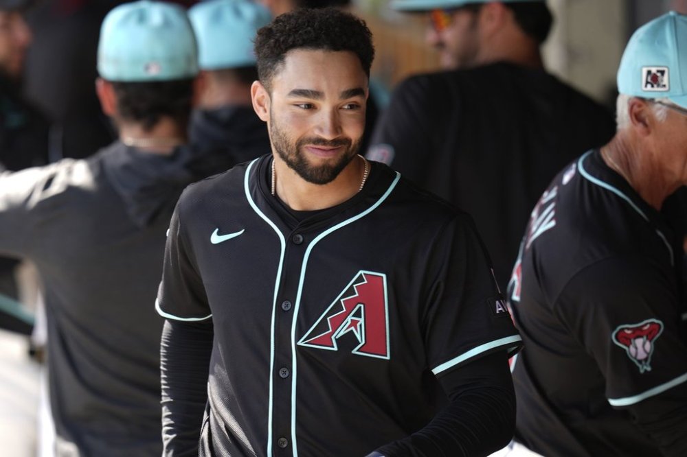 FILE - Arizona Diamondbacks' Jordan Lawlar walks through the dugout prior to a spring training baseball game against the Cleveland Guardians on Feb. 24, 2025, in Scottsdale, Ariz. (AP Photo/Ross D. Franklin, File)