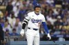 Los Angeles Dodgers' Shohei Ohtani smiles toward the Los Angeles Angels dugout before batting during the first inning of a baseball game Friday, May 16, 2025, in Los Angeles. (AP Photo/Mark J. Terrill)