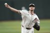 Arizona Diamondbacks starting pitcher Merrill Kelly warms up prior to a baseball game against the Colorado Rockies Sunday, May 18, 2025, in Phoenix. (AP Photo/Ross D. Franklin)