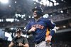 Houston Astros' Isaac Paredes, right, smiles as he comes off the field after hitting a three-run home run off Texas Rangers relief pitcher Robert Garcia during the eighth inning of a baseball game in Arlington, Texas, Sunday, May 18, 2025. (AP Photo/Jerome Miron)