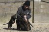 Sean Bly pets her German Shepherd puppies at the Strapestone Kennels in Radstock, England, Wednesday, March 5, 2025 as they will later in life become family protection dogs.(AP Photo/Frank Augstein)