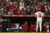 Fans applaud as Los Angeles Angels starting pitcher Yusei Kikuchi walks back to the dugout after being taken out during the sixth inning of a baseball game against the Miami Marlins, Friday, May 23, 2025, in Anaheim, Calif. (AP Photo/Mark J. Terrill)