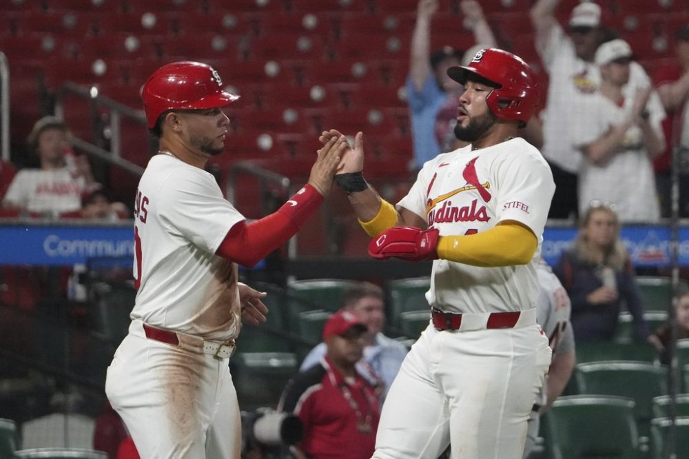 St. Louis Cardinals' Ivan Herrera, right and Willson Contreras celebrate after scoring during the seventh inning of a baseball game against the Detroit Tigers Monday, May 19, 2025, in St. Louis. (AP Photo/Jeff Roberson)