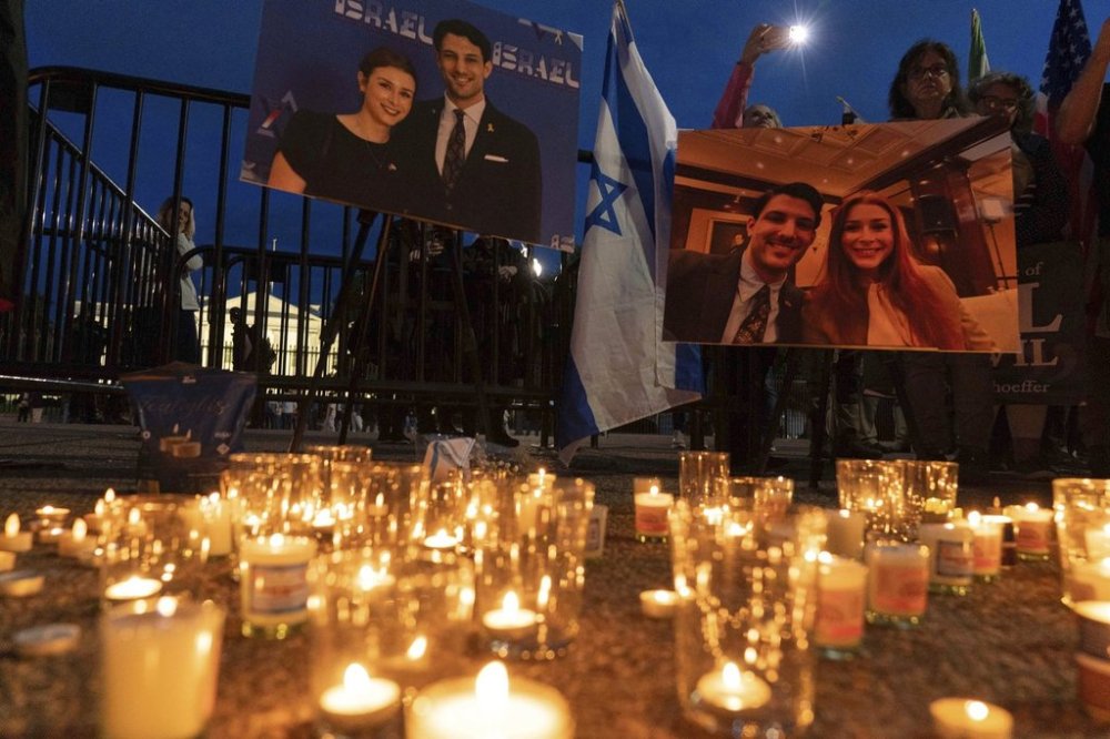 FILE - People gather to light candles in a makeshift memorial to honor Yaron Lischinsky and Sarah Milgrim who were killed as they left an event at the Capital Jewish Museum in Washington, during a candlelight vigil outside of the White House in Washington, Thursday, May 22, 2025. (AP Photo/Jose Luis Magana, file)