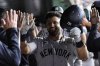 New York Yankees' Jasson Domínguez, center, is congratulated by teammates in the dugout after hitting a grand slam during the eighth inning of a baseball game against the Athletics, Friday, May 9, 2025, in West Sacramento, Calif. (AP Photo/Godofredo A. Vásquez)