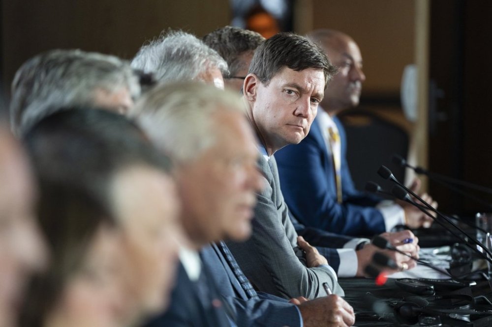 British Columbia Premier David Eby listens as Ontario Premier Doug Ford speaks to reporters as Canada's premiers hold a press conference to close the Council of the Federation meetings in Halifax on Wednesday, July 17, 2024. THE CANADIAN PRESS/Darren Calabrese