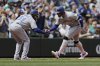 Toronto Blue Jays' George Springer, right, is congratulated by third base coach Carlos Febles, left, on his three-run home run off Seattle Mariners starting pitcher Bryce Miller during the fifth inning of a baseball game Sunday, May 11, 2025, in Seattle. (AP Photo/John Froschauer)