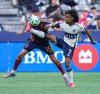 Vancouver Whitecaps' Jayden Nelson (7) and Real Salt Lake's Justen Glad (15) vie for the ball during the first half of an MLS soccer match, in Vancouver, on Saturday, May 3, 2025. THE CANADIAN PRESS/Darryl Dyck