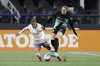 FILE - Seattle Reign FC midfielder Sam Meza, left, battles for the ball with NJ/NY Gotham FC forward Ella Stevens during an NWSL soccer match in Seattle, March 15, 2025. (AP Photo/John Froschauer, file)