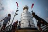 Kids from Pierceland, Sask., in the city on vacation, stop to touch and look at a nearly 4 metre replica of the Stanley Cup trophy that is a permanent installation, in Edmonton, on Tuesday, June 3, 2025. The Edmonton Oilers and Florida Panthers are scheduled to play game 1 of the Stanley Cup Final in Edmonton on Wednesday. THE CANADIAN PRESS/Darryl Dyck